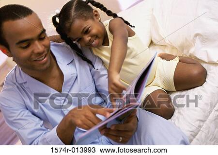 Close-up of a father teaching his daughter View Large Photo Image Stock Image - Close-up of a father teaching his daughter. Fotosearch