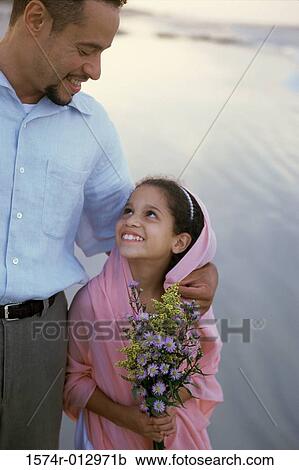 Close-up of a father walking with his daughter on the beach View Large Photo Image Stock Image - Close-up of a father walking with his daughter on the beach. Fotosearch