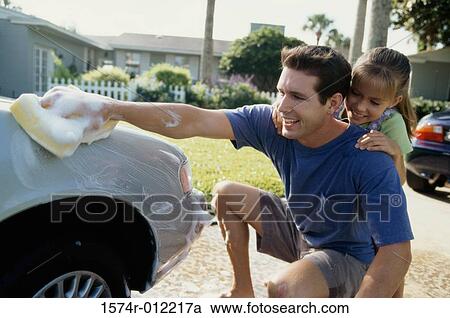 Close-up of a father washing a car with his daughter leaning on him View Large Photo Image Stock Image - Close-up of a father washing a car with his daughter leaning on him. Fotosearch