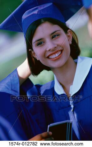 Stock Image - Close-up of a female teenage graduate smiling. Fotosearch