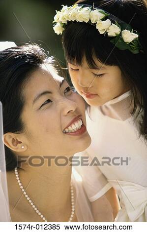 Close-up of a flower girl kissing a bride on the cheek View Large Photo Image Stock Photography - Close-up of a flower girl kissing a bride on the cheek. Fotosearch