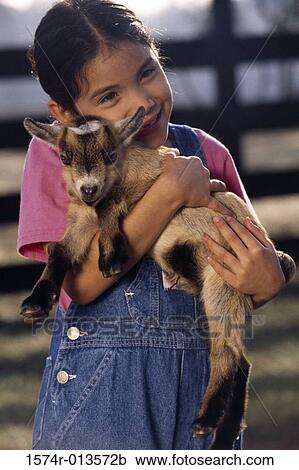 Close-up of a girl carrying a lamb View Large Photo Image Stock Image - Close-up of a girl carrying a lamb. Fotosearch