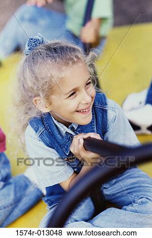 Close-up of a girl on a merry-go-round View Large Photo Image Stock Photo - Close-up of a girl on a merry-go-round. Fotosearch