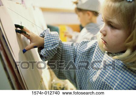 Stock Image - Close-up of a girl painting. Fotosearch