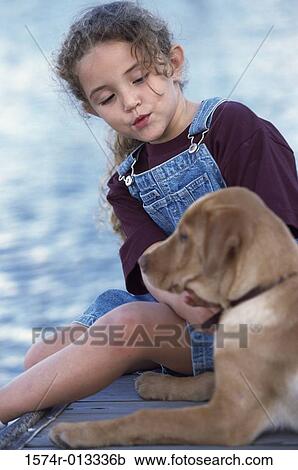 Close-up of a girl sitting with her dog View Large Photo Image Stock Image - Close-up of a girl sitting with her dog. Fotosearch