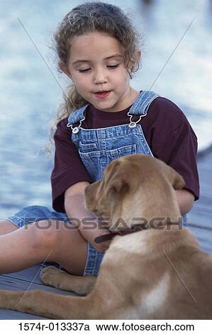 Close-up of a girl sitting with her dog View Large Photo Image Stock Image - Close-up of a girl sitting with her dog. Fotosearch
