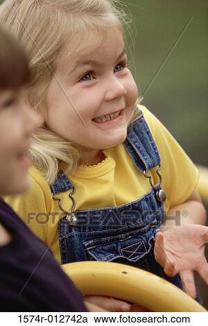 Close-up of a girl smiling View Large Photo Image Stock Image - Close-up of a girl smiling. Fotosearch