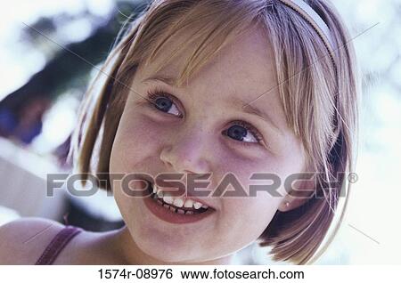 Stock Photograph - Close-up of a girl smiling. Fotosearch