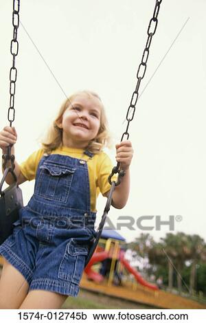 Close-up of a girl swinging on a swing View Large Photo Image Stock Image - Close-up of a girl swinging on a swing. Fotosearch