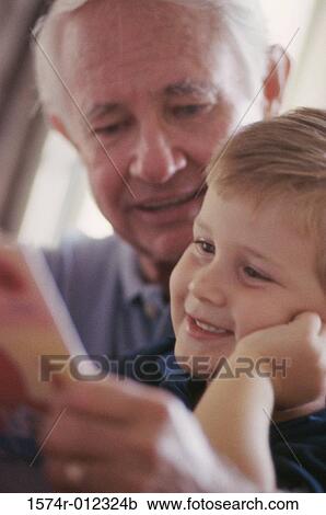 Stock Image - Close-up of a grandfather smiling with his grandson. Fotosearch