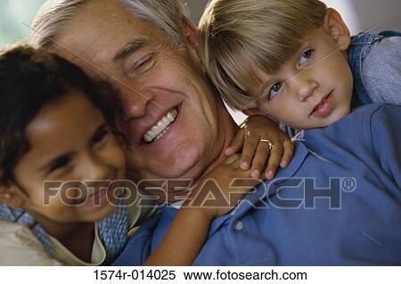 Close-up of a grandfather smiling with his grandson and granddaughter View Large Photo Image Stock Photography - Close-up of a grandfather smiling with his grandson and granddaughter. Fotosearch