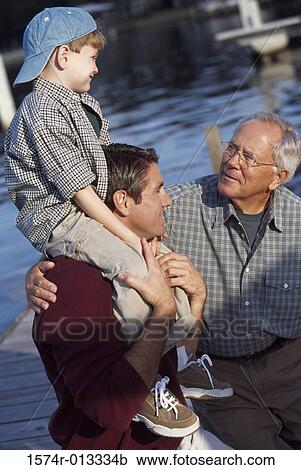 Close-up of a grandfather with his son and grandson View Large Photo Image Stock Image - Close-up of a grandfather with his son and grandson. Fotosearch