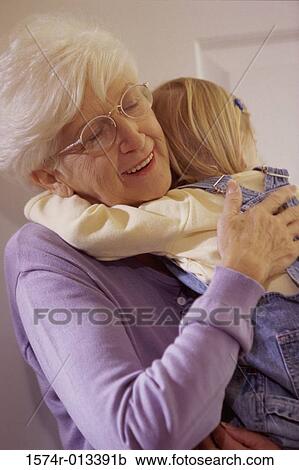 Close-up of a grandmother hugging her granddaughter View Large Photo Image Stock Image - Close-up of a grandmother hugging her granddaughter. Fotosearch