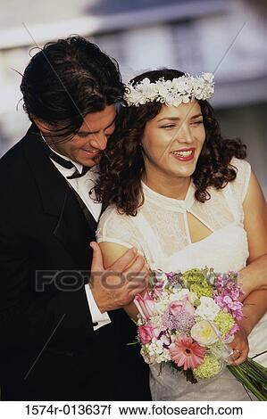 Close-up of a groom embracing his bride from behind View Large Photo Image Stock Image - Close-up of a groom embracing his bride from behind. Fotosearch