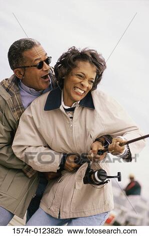 Close-up of a mature couple holding a fishing rod View Large Photo Image Stock Image - Close-up of a mature couple holding a fishing rod. Fotosearch