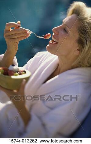 Close-up of a mature woman eating fruit salad View Large Photo Image Stock Image - Close-up of a mature woman eating fruit salad. Fotosearch