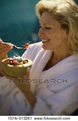 Close-up of a mature woman holding a bowl of fruit salad View Large Photo Image Stock Image - Close-up of a mature woman holding a bowl of fruit salad. Fotosearch