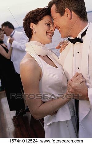 Close-up of a mid adult couple dancing on the deck of a cruise ship View Large Photo Image Picture - Close-up of a mid adult couple dancing on the deck of a cruise ship. Fotosearch
