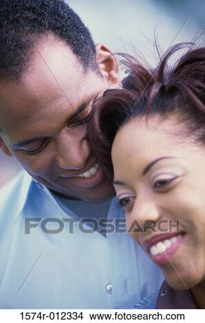Close-up of a mid adult couple smiling View Large Photo Image Picture - Close-up of a mid adult couple smiling. Fotosearch
