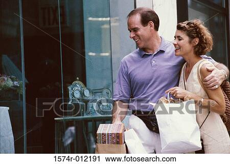 Close-up of a mid adult couple window shopping View Large Photo Image Stock Image - Close-up of a mid adult couple window shopping. Fotosearch