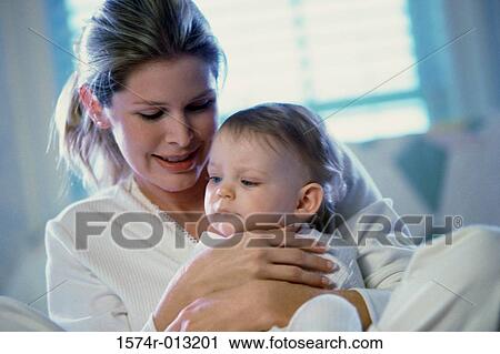 Close-up of a mother holding her son View Large Photo Image Stock Image - Close-up of a mother holding her son. Fotosearch