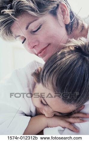 Stock Image - Close-up of a mother hugging her daughter. Fotosearch