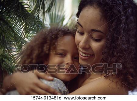 Close-up of a mother hugging her daughter View Large Photo Image Stock Image - Close-up of a mother hugging her daughter. Fotosearch