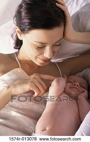 Stock Photo - Close-up of a mother lying in bed with her son. Fotosearch
