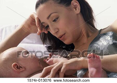 Stock Photograph - Close-up of a mother lying in bed with her son. Fotosearch