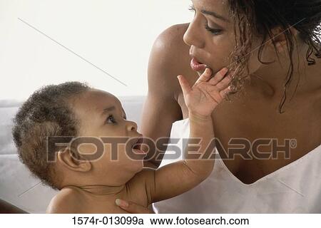 Close-up of a mother playing with her son View Large Photo Image Stock Image - Close-up of a mother playing with her son. Fotosearch