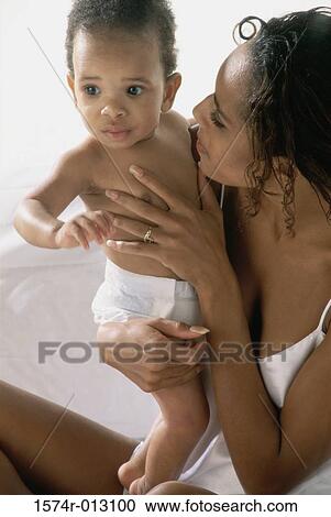 Close-up of a mother playing with her son View Large Photo Image Stock Image - Close-up of a mother playing with her son. Fotosearch