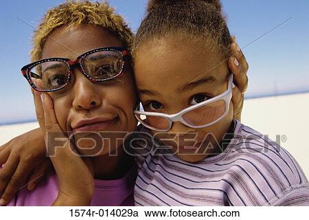 Close-up of a mother with her daughter on the beach View Large Photo Image Stock Image - Close-up of a mother with her daughter on the beach. Fotosearch