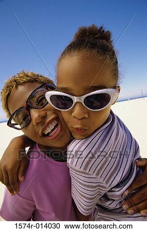 Stock Image - Close-up of a mother with her daughter on the beach. Fotosearch