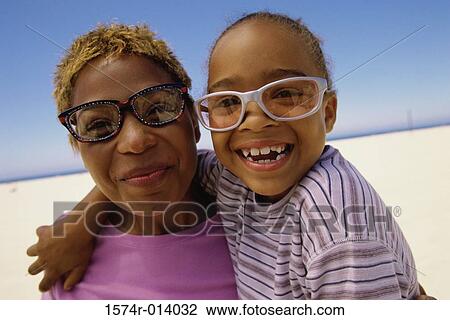 Close-up of a mother with her daughter on the beach View Large Photo Image Stock Image - Close-up of a mother with her daughter on the beach. Fotosearch