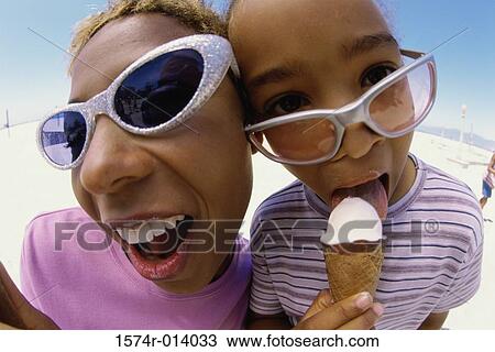 Stock Image - Close-up of a mother with her daughter on the beach. Fotosearch