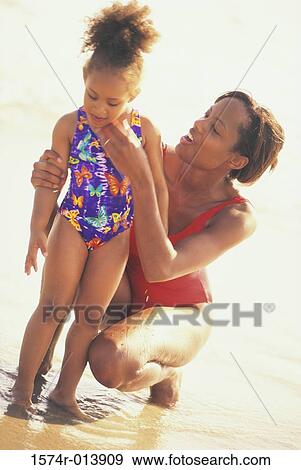 Stock Photo - Close-up of a mother with her daughter on the beach. Fotosearch