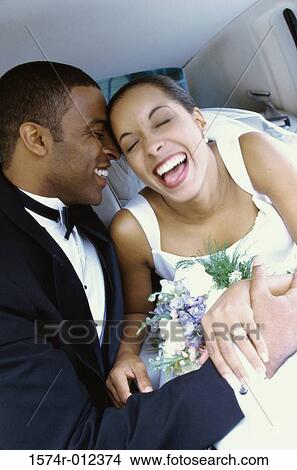 Picture - Close-up of a newlywed couple smiling in a limousine. Fotosearch