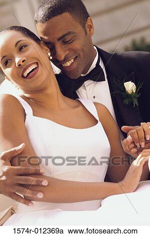 Stock Image - Close-up of a newlywed couple smiling. Fotosearch