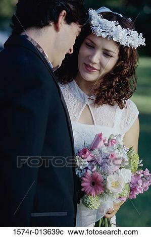 Close-up of a newlywed couple talking to each other View Large Photo Image Stock Image - Close-up of a newlywed couple talking to each other. Fotosearch