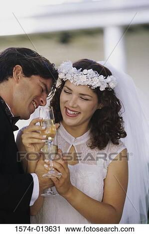 Close-up of a newlywed couple toasting with champagne View Large Photo Image Stock Image - Close-up of a newlywed couple toasting with champagne. Fotosearch