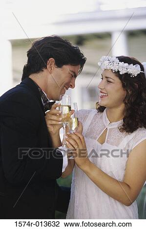 Close-up of a newlywed couple toasting with champagne View Large Photo Image Stock Image - Close-up of a newlywed couple toasting with champagne. Fotosearch