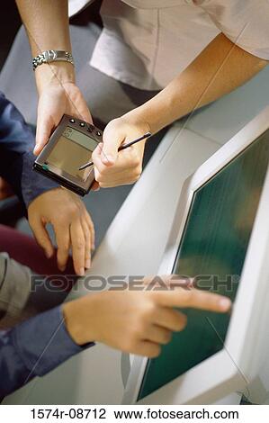 Close-up of a person operating a handheld device View Large Photo Image Stock Image - Close-up of a person operating a handheld device. Fotosearch