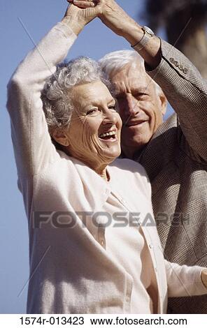 Stock Image - Close-up of a senior couple dancing. Fotosearch