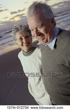 Close-up of a senior couple standing on the beach View Large Photo Image Picture - Close-up of a senior couple standing on the beach. Fotosearch