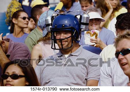 Close-up of a spectator wearing a football helmet View Large Photo Image Stock Image - Close-up of a spectator wearing a football helmet. Fotosearch