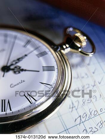 Stock Image - Close-up of a stopwatch on sheets of paper. Fotosearch