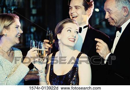 Close-up of a young couple and a senior couple holding wineglasses in a nightclub View Large Photo Image Stock Image - Close-up of a young couple and a senior couple holding wineglasses in a nightclub. Fotosearch