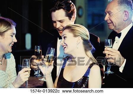 Close-up of a young couple and senior couple holding glasses of champagne at a bar View Large Photo Image Stock Image - Close-up of a young couple and senior couple holding glasses of champagne at a bar. Fotosearch