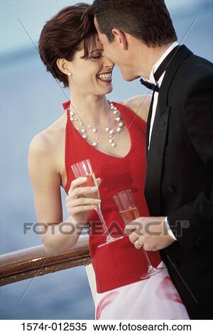 Close-up of a young couple holding champagne flutes on the deck of a cruise ship View Large Photo Image Stock Photography - Close-up of a young couple holding champagne flutes on the deck of a cruise ship. Fotosearch