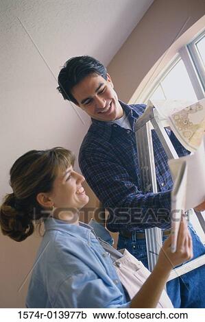 Stock Image - Close-up of a young couple reading a book. Fotosearch